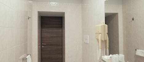 A modern bathroom with a toilet, bidet, and sink.