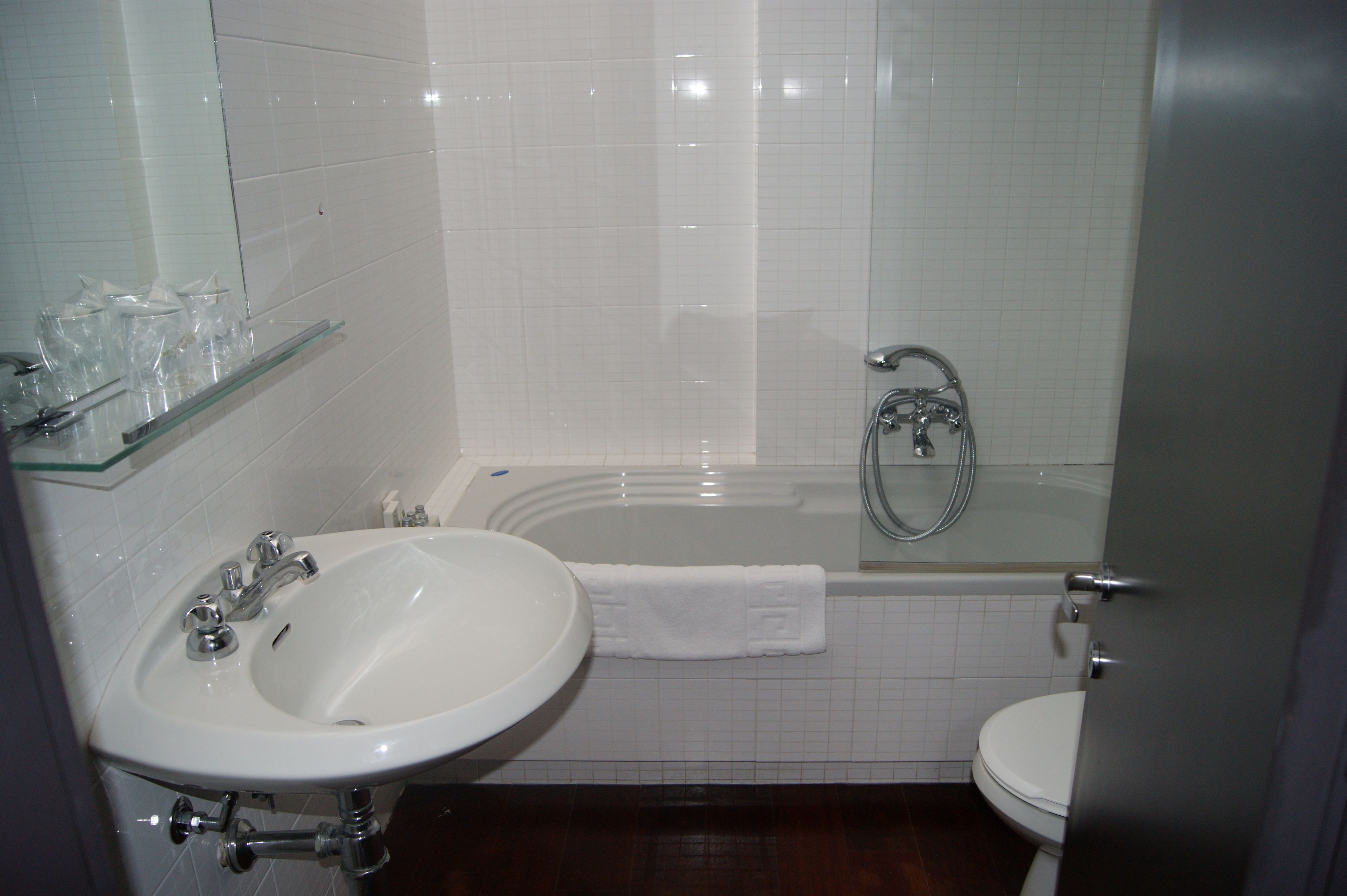 A bathroom with a sink, toilet, and bathtub.