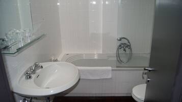 A bathroom with a sink, toilet, and bathtub.