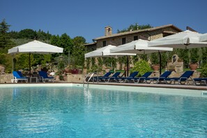 Seasonal outdoor pool, open 7:30 AM to 7:30 PM, pool umbrellas