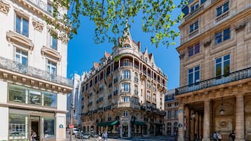 A historic building with ornate architecture, large windows, and balconies.