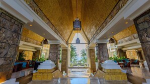 A grand lobby with high ceilings, intricate stone carvings, and a central chandelier. - Barceló Karmina All Inclusive (Manzanillo)