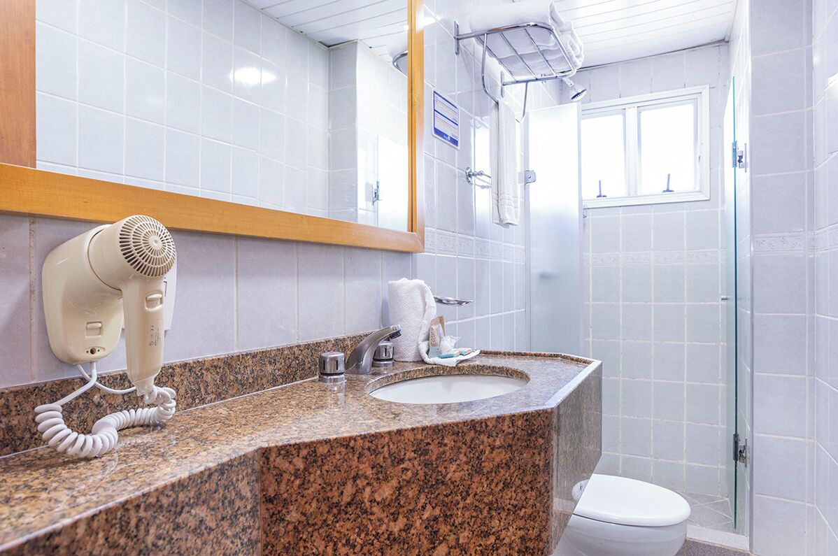 standard double room | bathroom | shower, eco-friendly toiletries, hair dryer, towels