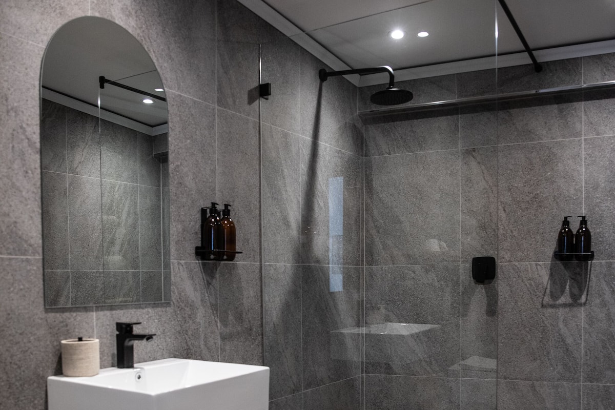 Separate bathtub and shower, hair dryer, towels