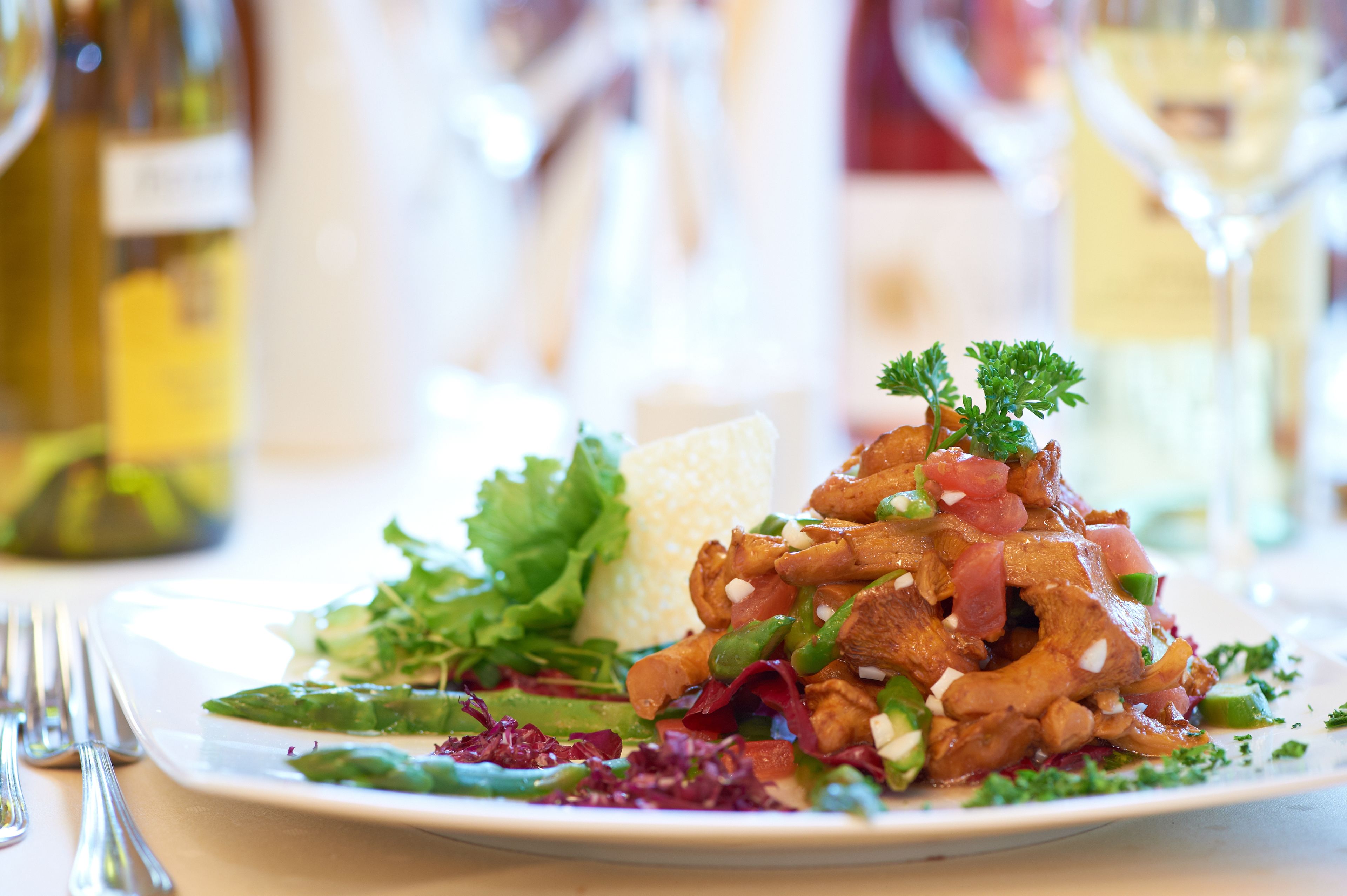 A plate of food with various vegetables and a garnish.