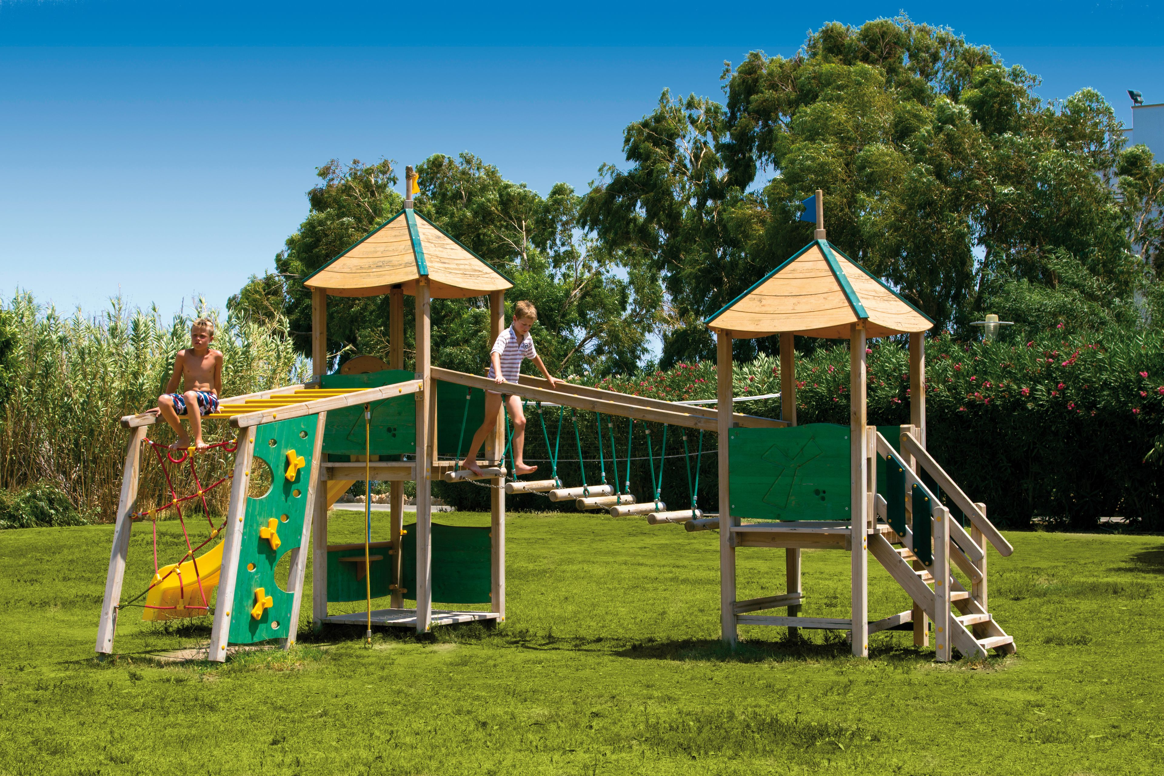 A playground with climbing structures and slides.
