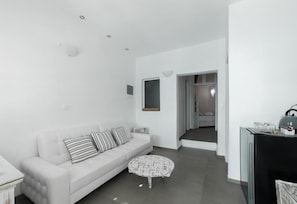Deluxe Two Bedroom Apartment, Private Terrace & Hot Tub | Living area | Flat-screen TV - Amoudi Villas (Santorini)