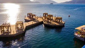 A pier with seating areas and a boat docked at the end.