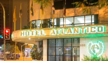 A hotel named 'HOTEL ATLANTICO' with a prominent sign and a logo featuring a laurel wreath.