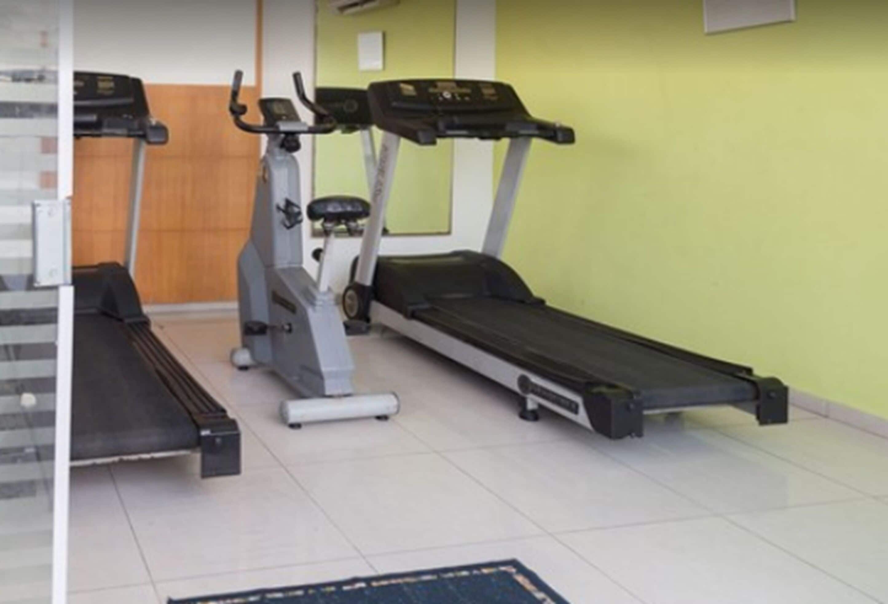 A gym with treadmills and an elliptical machine.