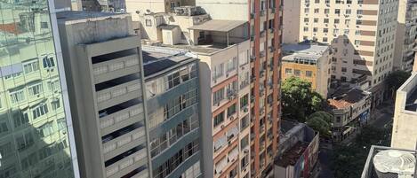 A high-rise building with multiple floors, large windows, and balconies.