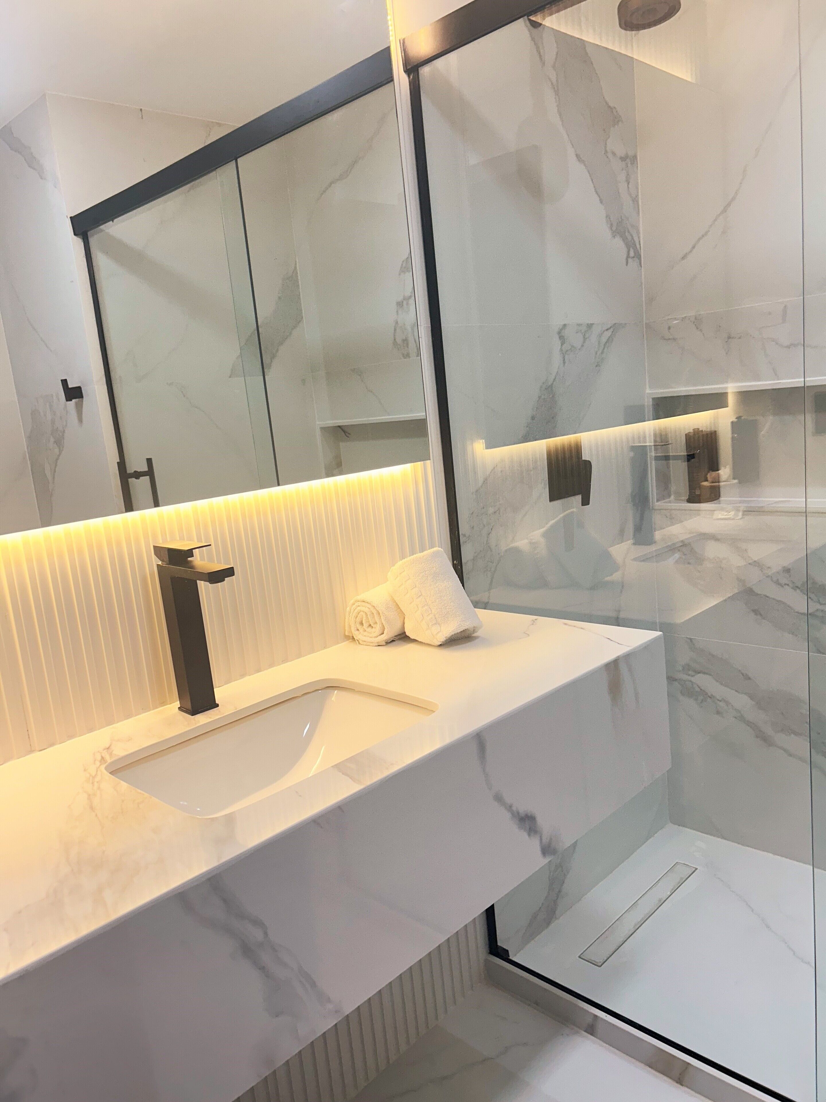 deluxe quadruple room | bathroom | shower, hair dryer, towels, soap