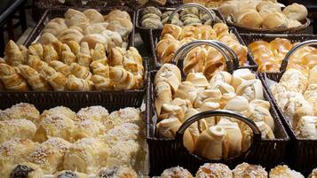 A bakery display with various baked goods in baskets.