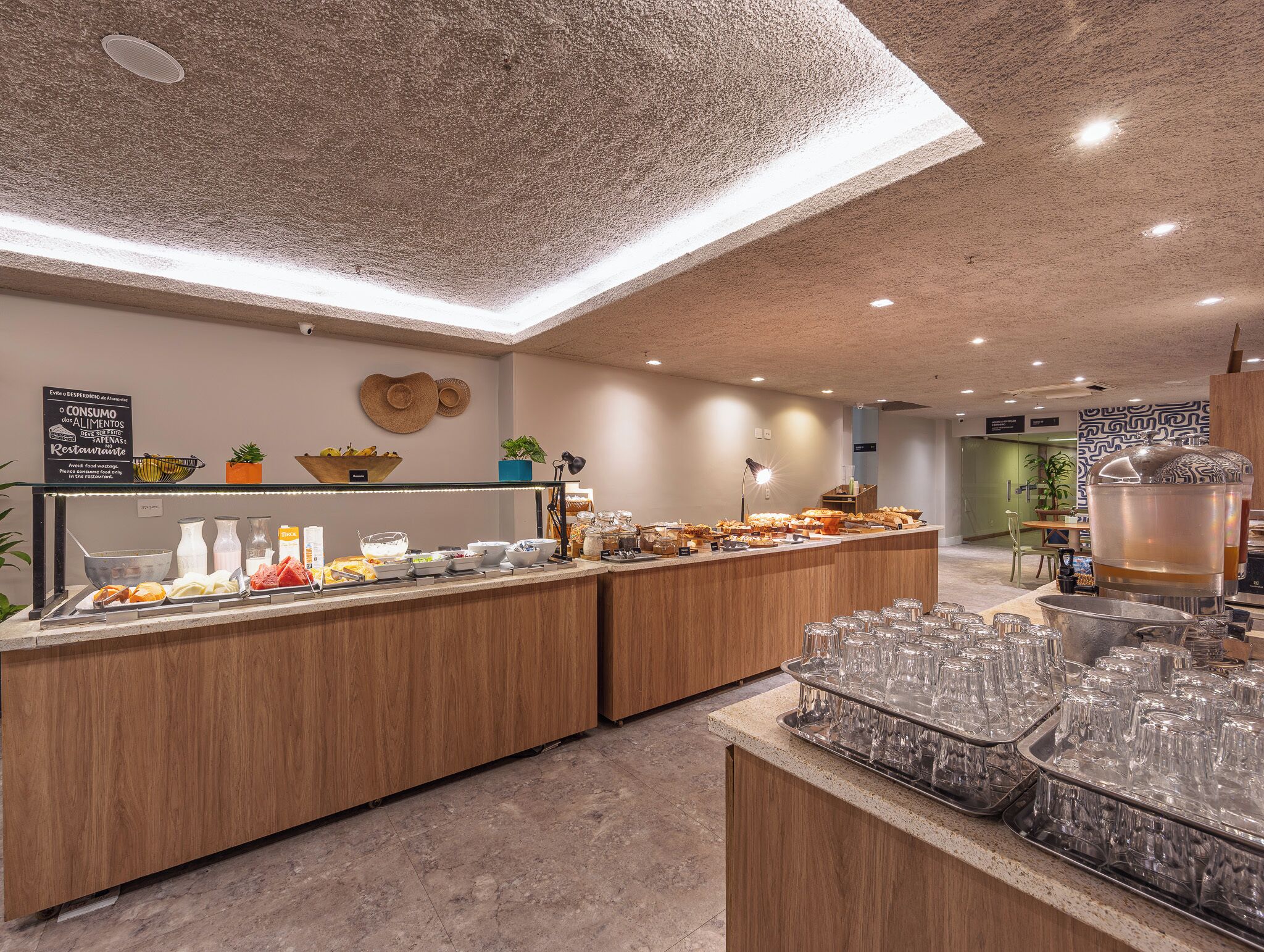 A buffet area with a variety of food items and a glassware station.