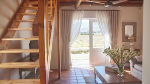 A wooden staircase leading to a room with a view of the outdoors. - Klein Waterval Riverside Lodge (Franschhoek)