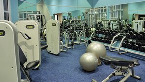 A gym with various exercise equipment, including dumbbells and exercise balls. - The Portswood Hotel (Cape Town)