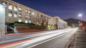 A multi-story hotel with a modern facade, a visible entrance, and a parking area. - The Portswood Hotel (Cape Town)