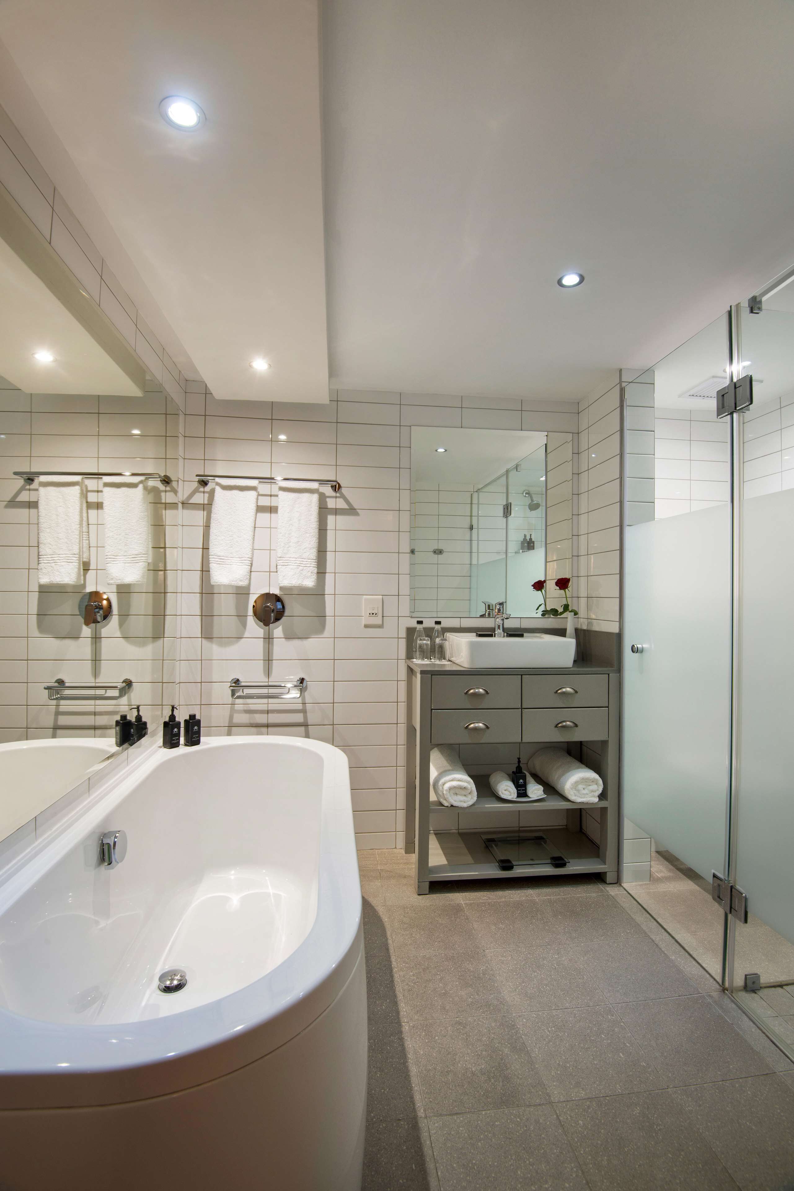 studio king with shower and bath | bathroom | designer toiletries, hair dryer, towels, soap