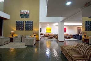 Relax in a spacious lobby with comfortable seating and artwork adorning the walls.