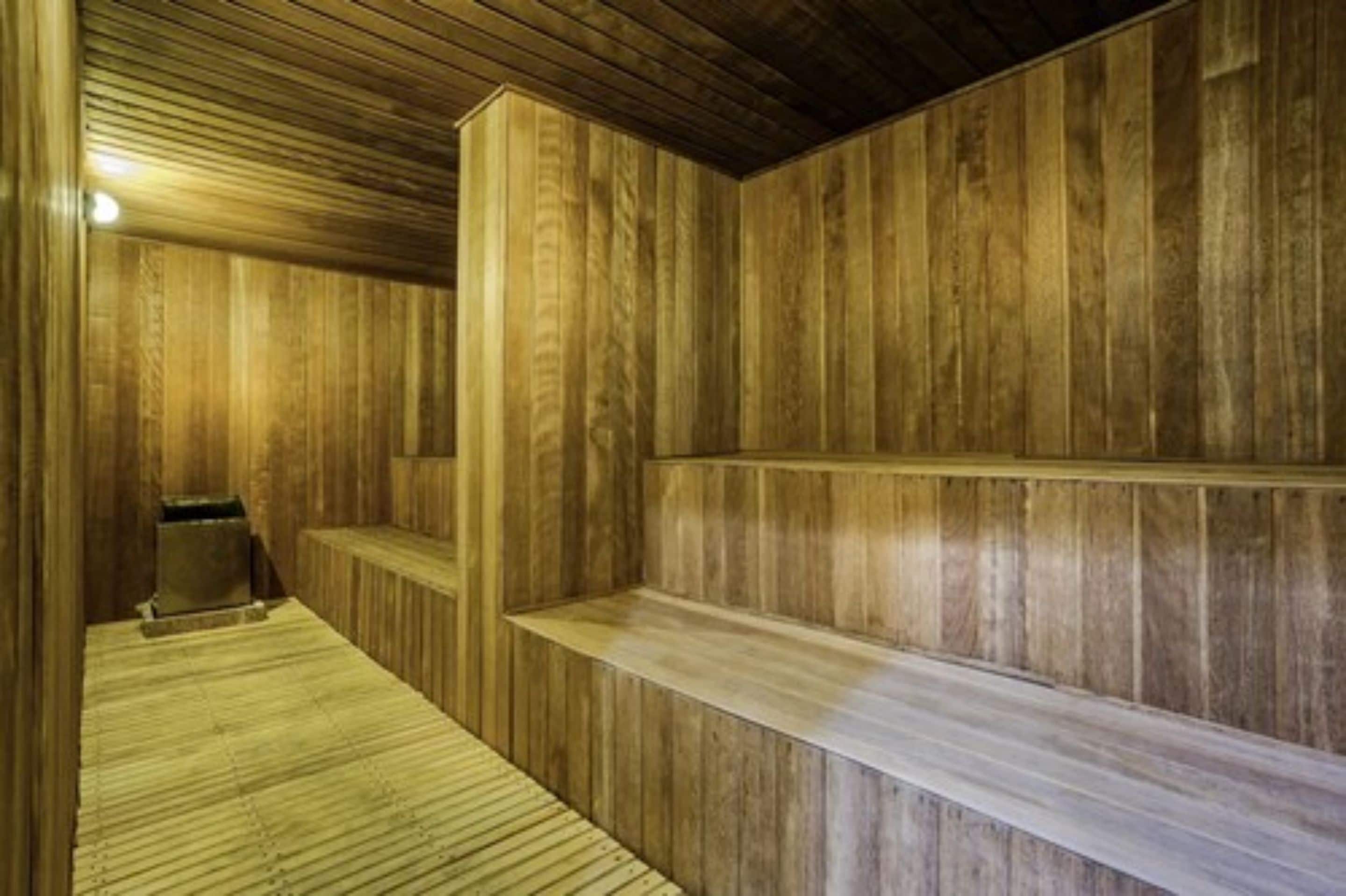 A sauna with wooden walls and benches.