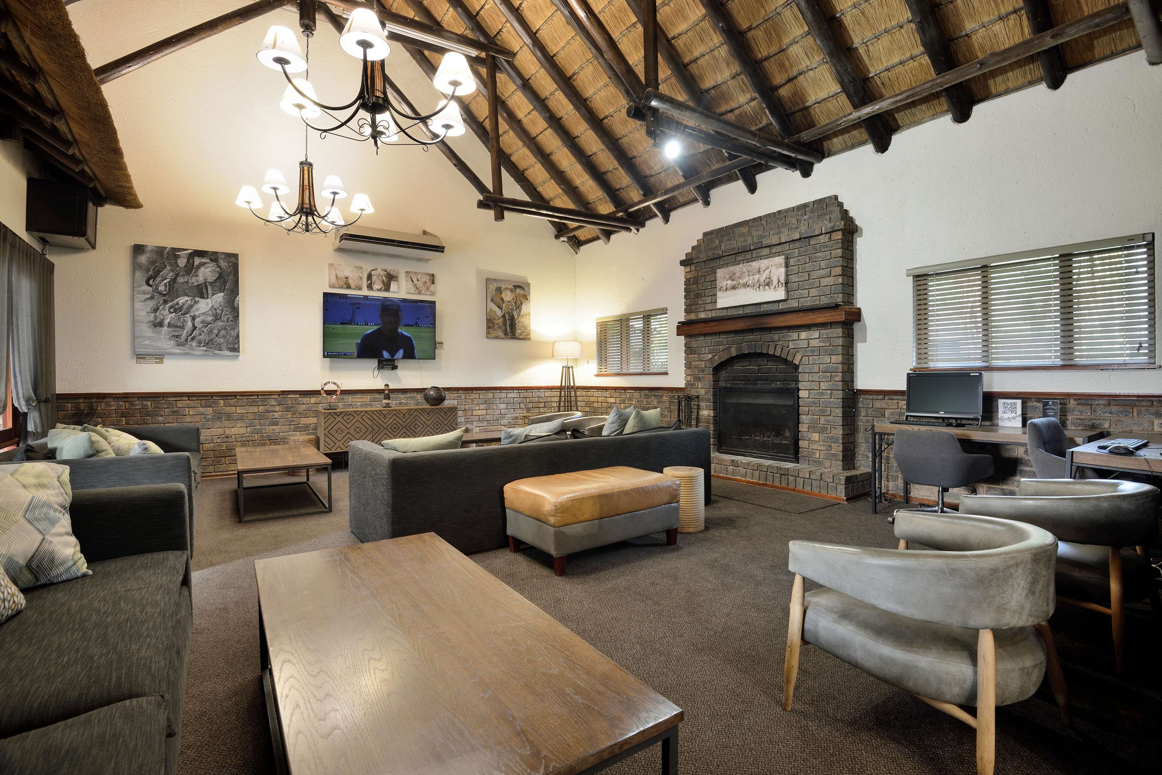 A cozy living room with a fireplace, comfortable seating, and a television.