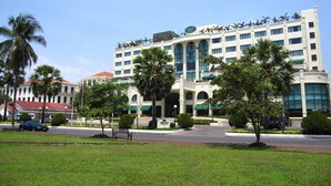A large hotel with multiple floors, a central atrium, and a parking area in front. - Sunway Hotel Phnom Penh (Phnom Penh)