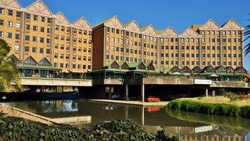 A multi-story hotel with a central courtyard and a canal.