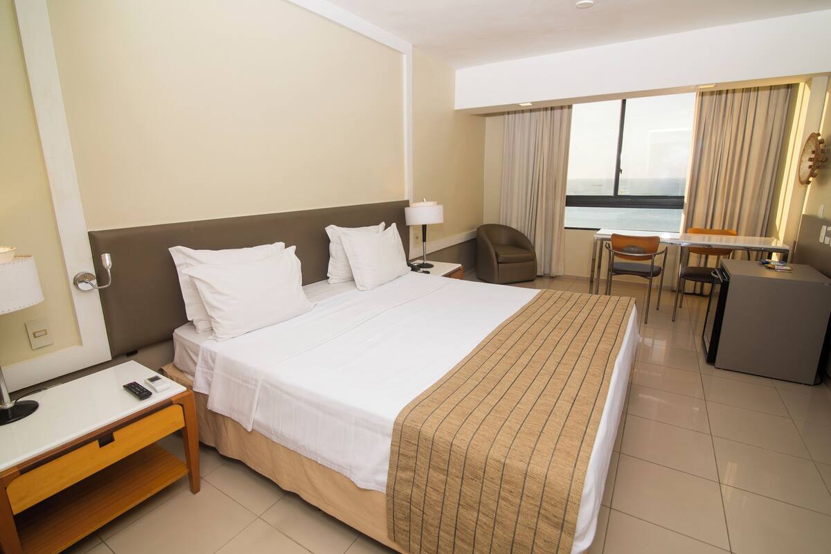 Deluxe Room, Sea View | Minibar, in-room safe, desk, laptop workspace