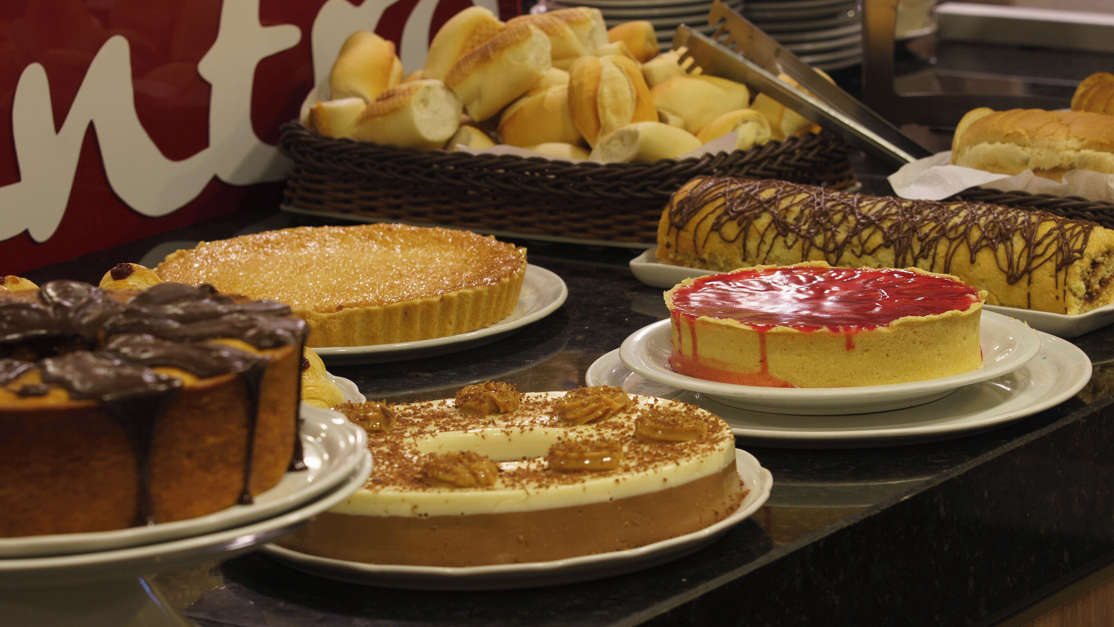 A variety of desserts on display, including cakes and pastries.