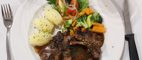 A plate with meat, potatoes, and vegetables.