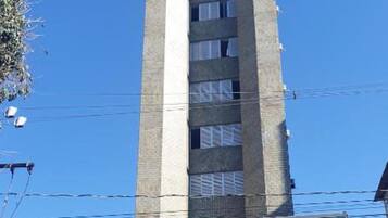 A hotel with a modern design, featuring a tall tower and a flat facade.