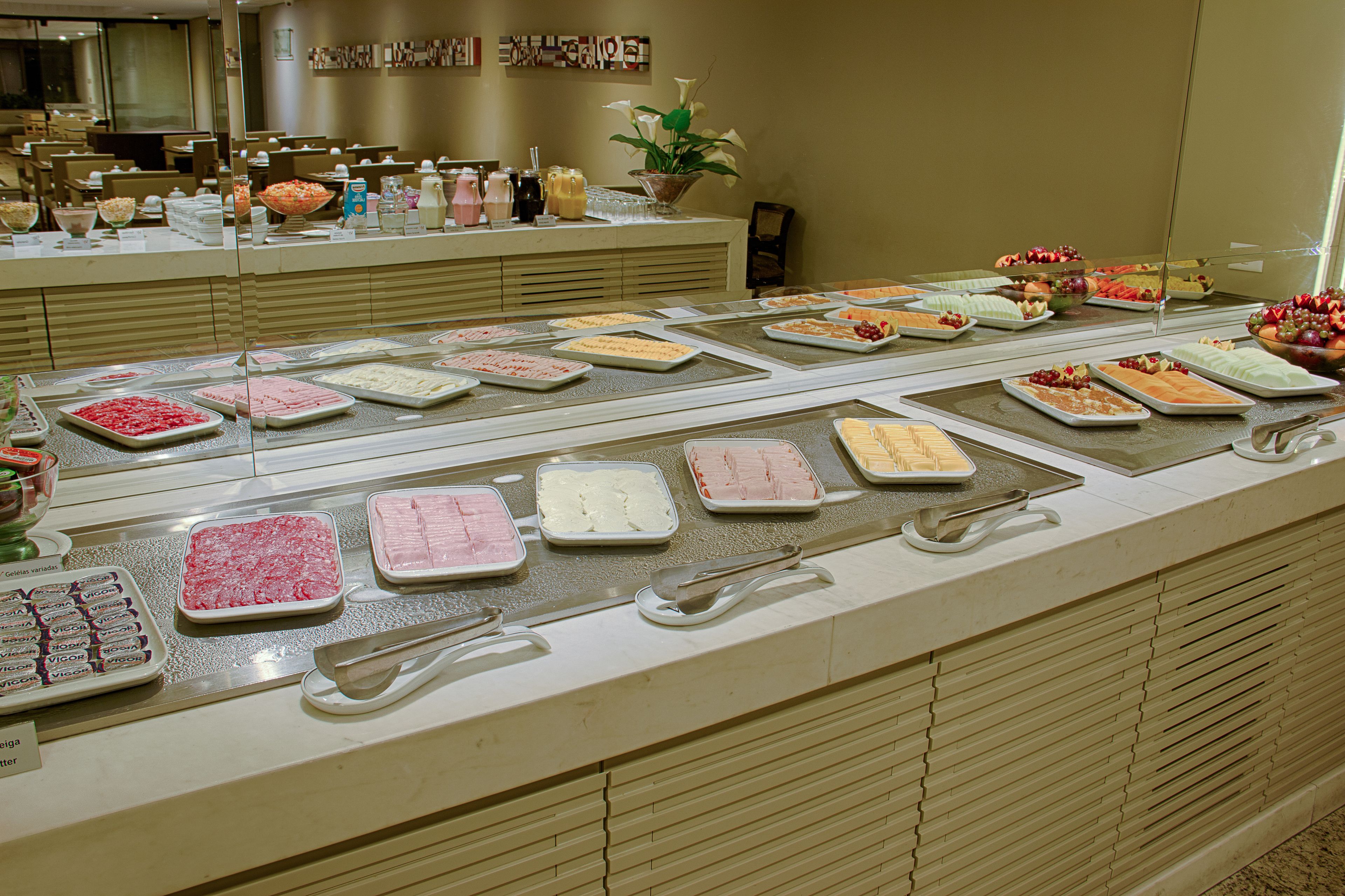 A buffet with various food items displayed in trays.