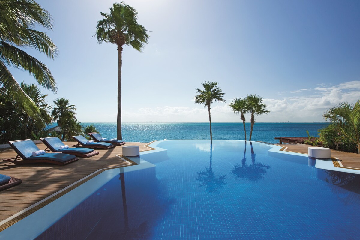 Zoetry Villa Rolandi infinity pool area with an ocean view
