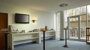 A modern bathroom with a sink, mirror, and a flat-screen TV mounted on the wall. - Sunday Hotel Kassel (Kassel)