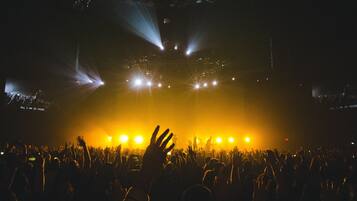 A concert with a crowd of people and stage lighting.