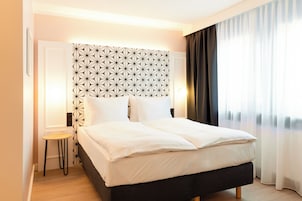 Hypo-allergenic bedding, desk, laptop workspace, blackout drapes