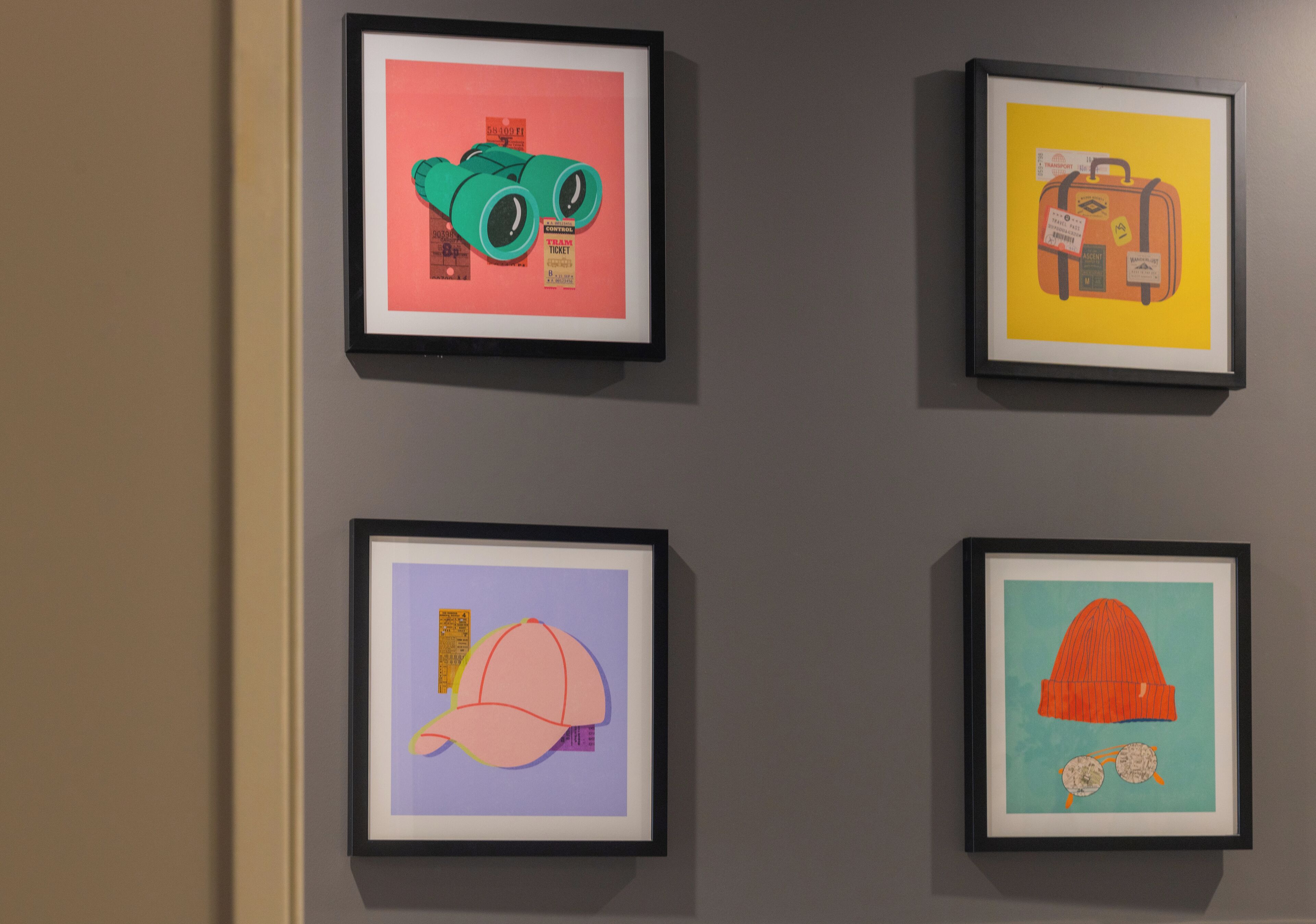 Four framed artworks on a wall.