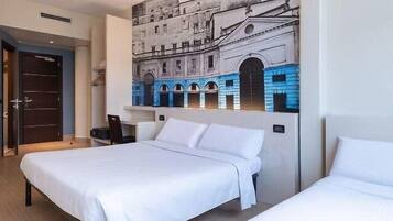 A hotel room with two beds, a large mural of a building, and a door leading to another room.