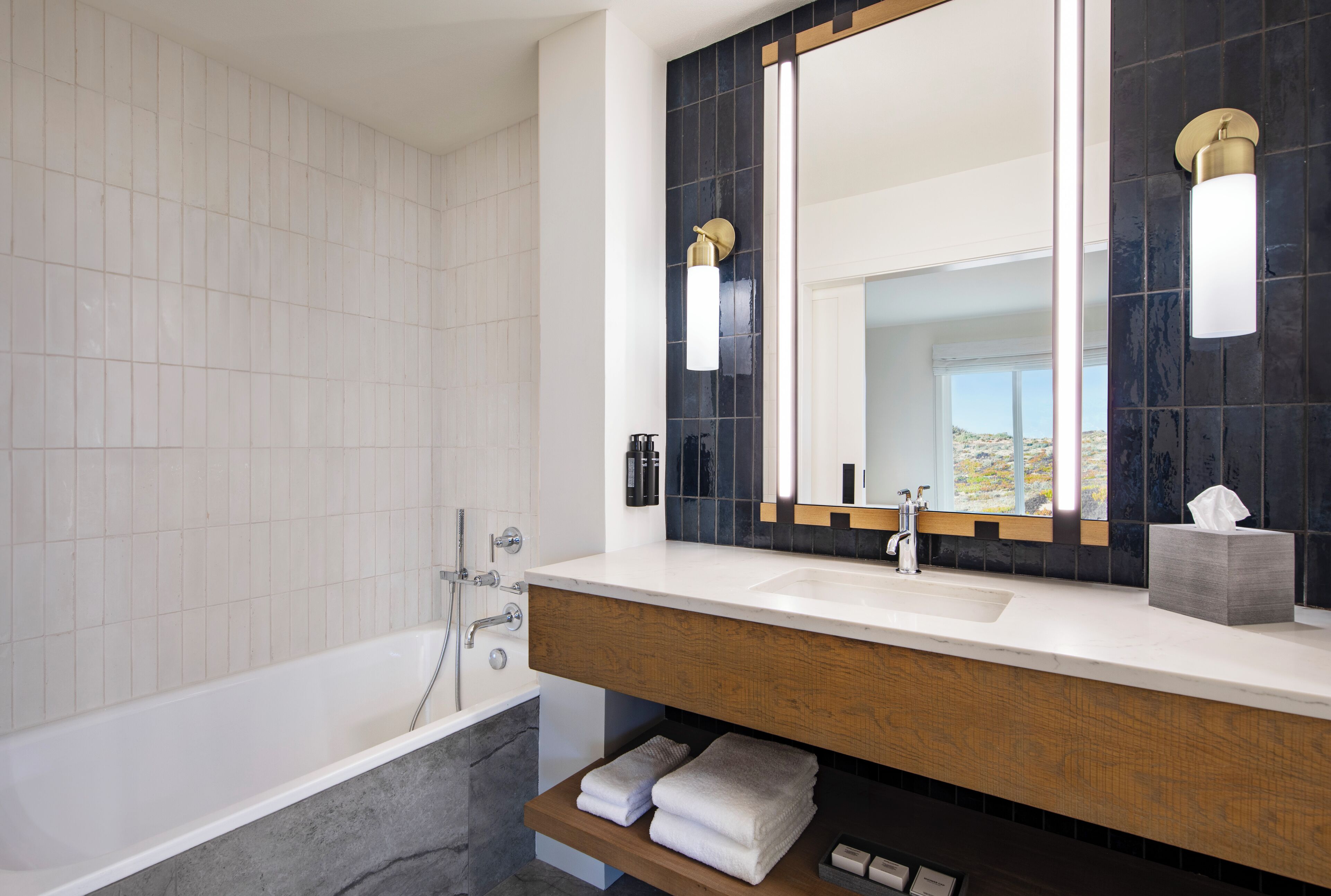 designer toiletries, hair dryer, bathrobes, slippers