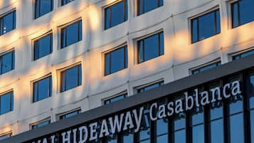 A building facade with a repeating pattern of windows and the text 'ROYAL HIDEAWAY Casablanca' indicating the hotel's name.