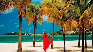 On the beach, white sand, beach cabanas, beach umbrellas