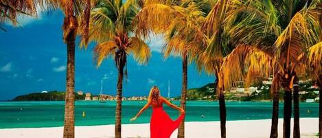 On the beach, white sand, beach cabanas, beach umbrellas