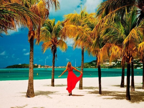 On the beach, white sand, beach cabanas, beach umbrellas