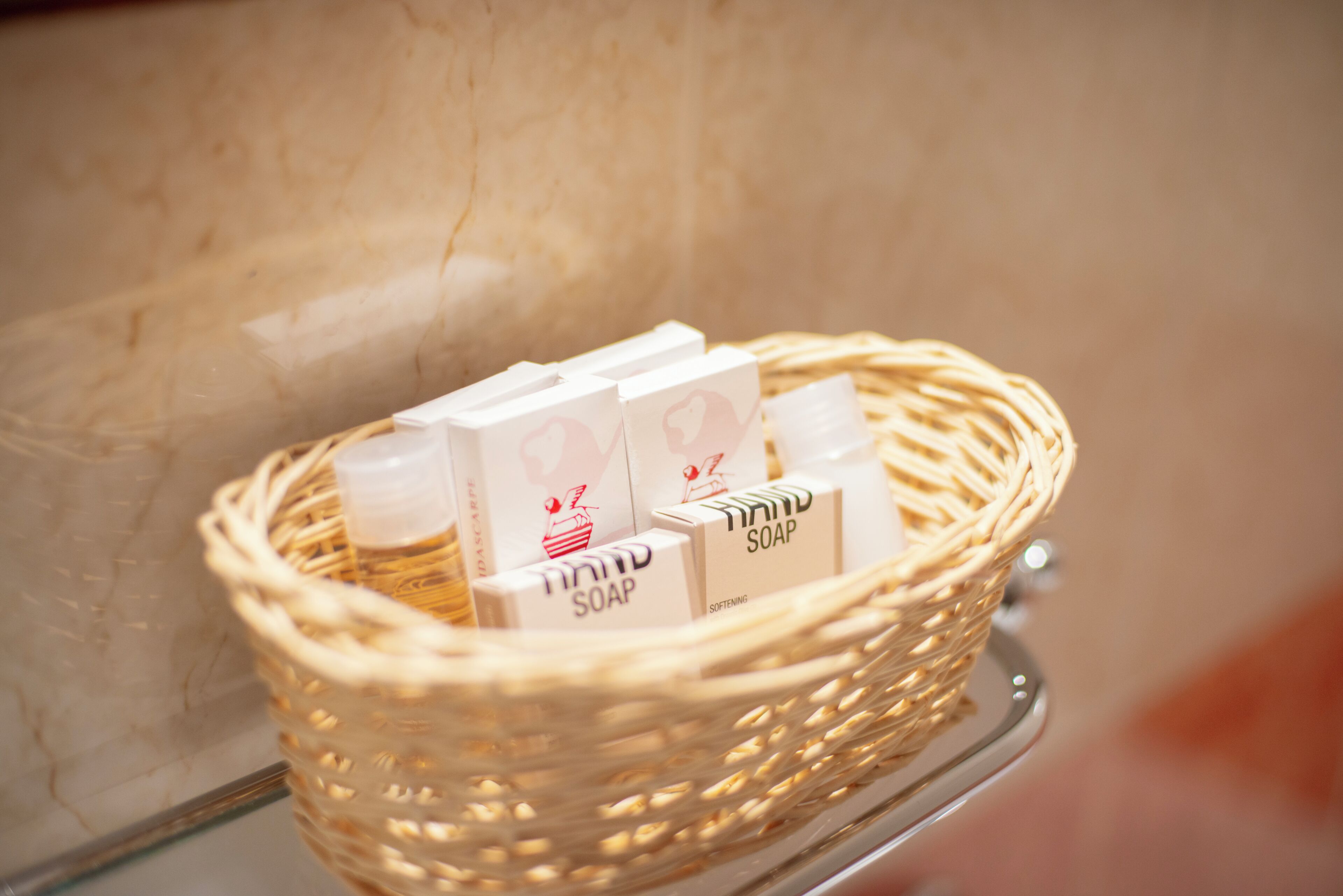 A wicker basket containing soap bars on a shelf.