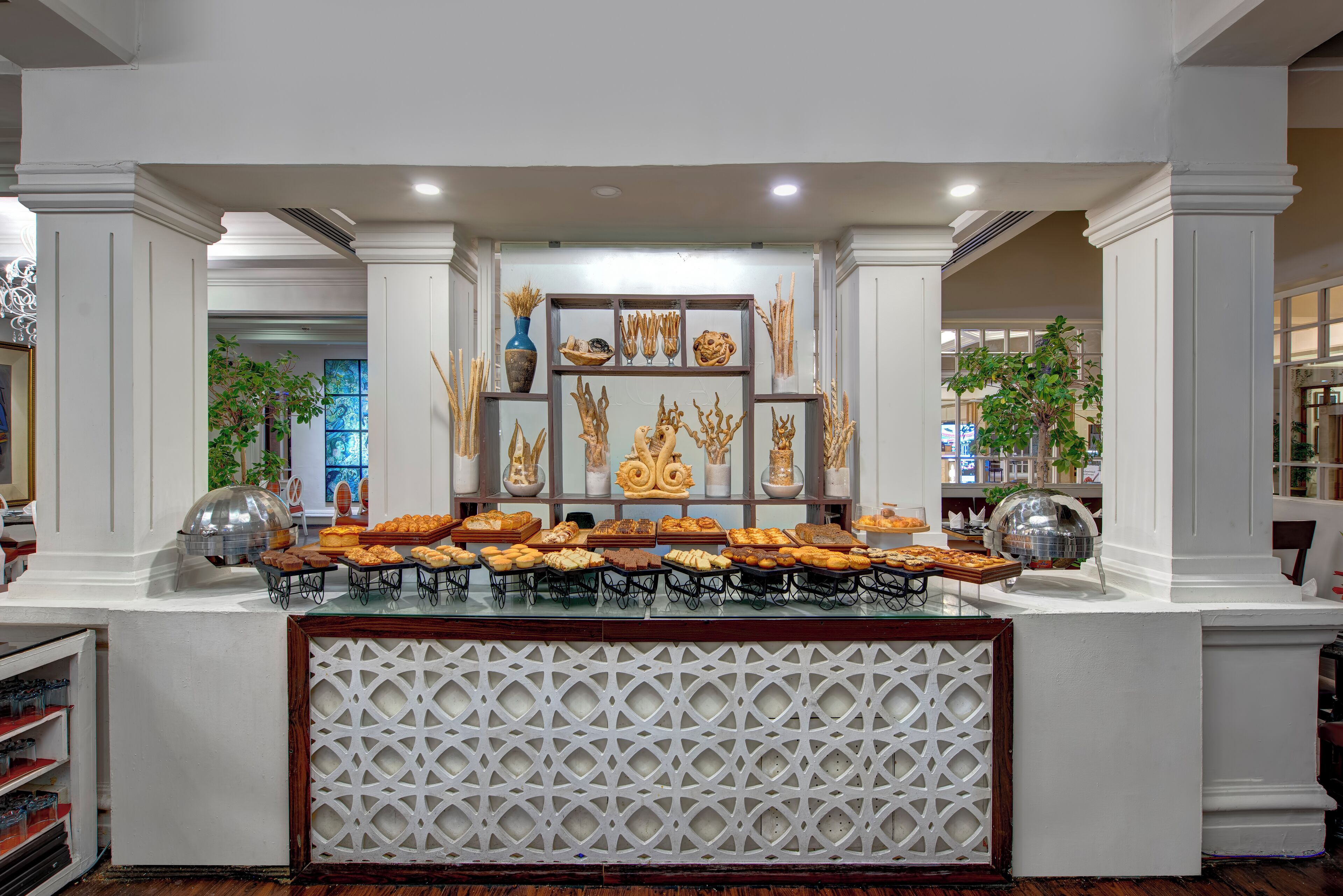 A buffet area with various food items and decorative elements.