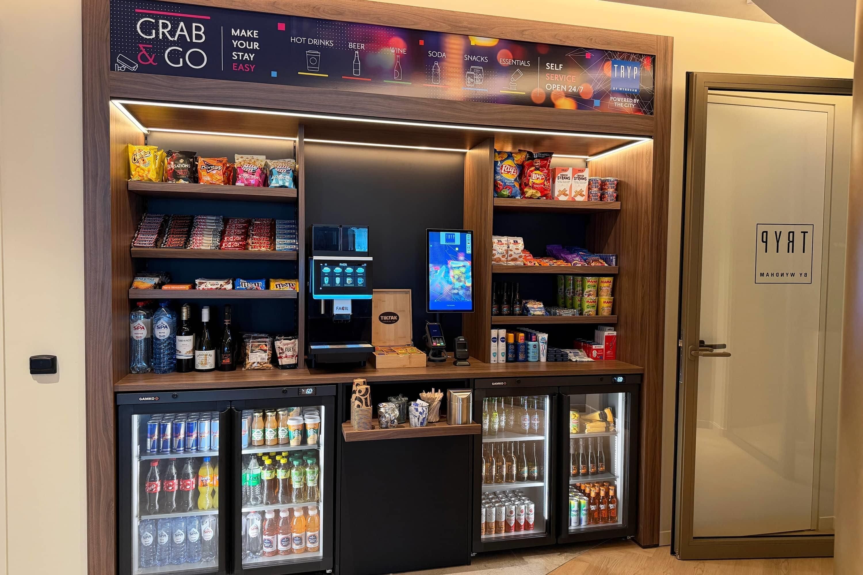 A self-service kiosk area with a variety of snacks, beverages, and a coffee machine.