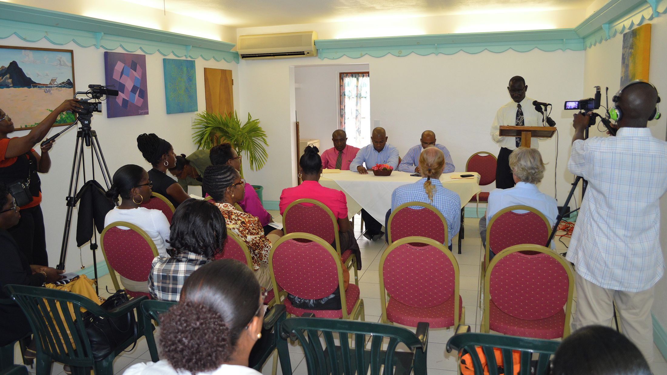 Une salle de conférence équipée d’une table, de chaises et accueillant des participants.