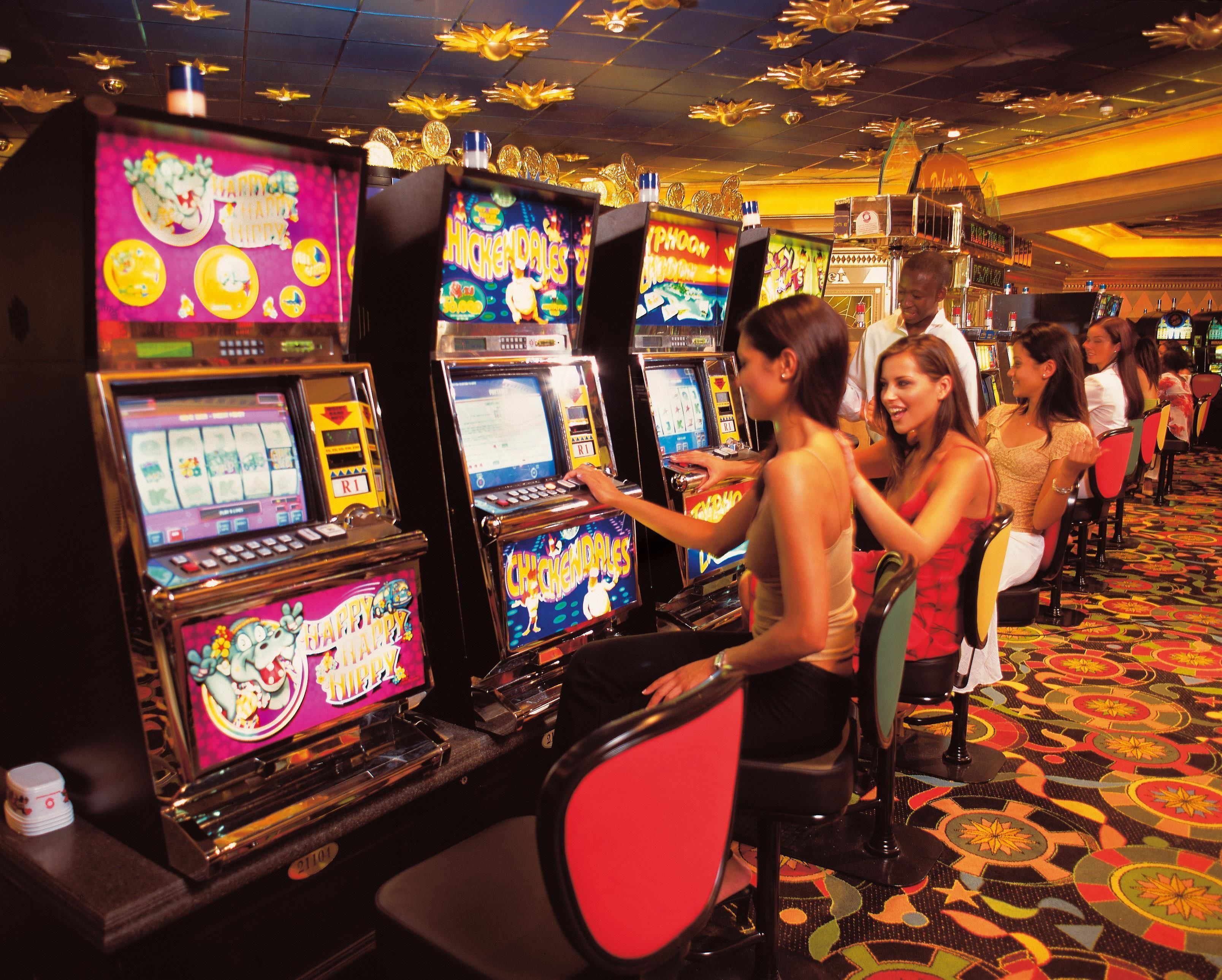 A casino floor with slot machines and a patterned carpet.