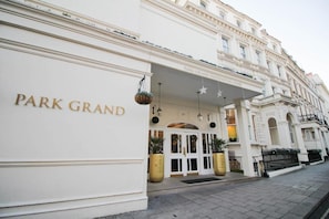 A grand entrance with a white facade and the name 'PARK GRAND' in gold lettering. - Sunday London Paddington Hotel (London)
