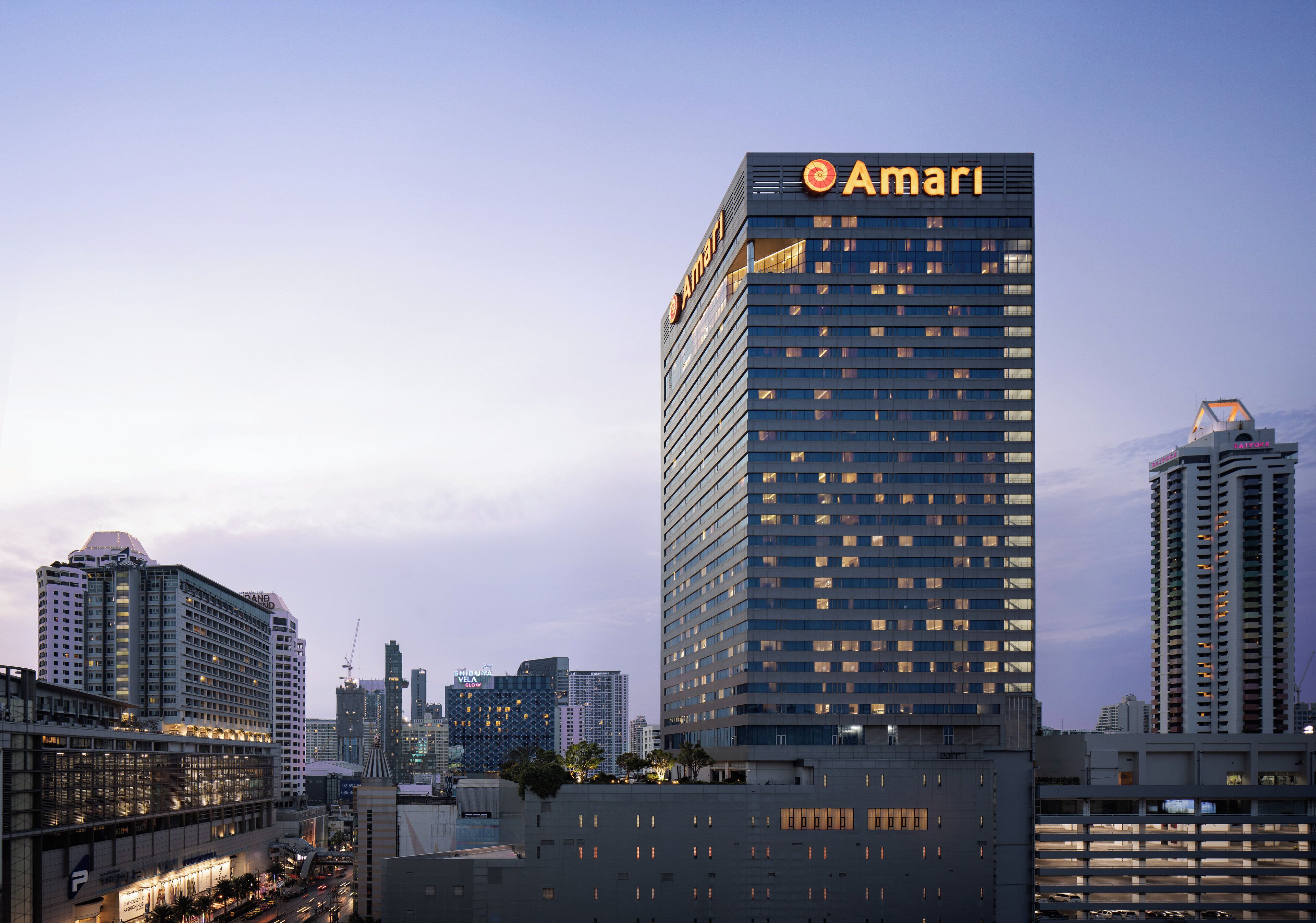 A high-rise hotel with the name 'Amari' prominently displayed on the top.